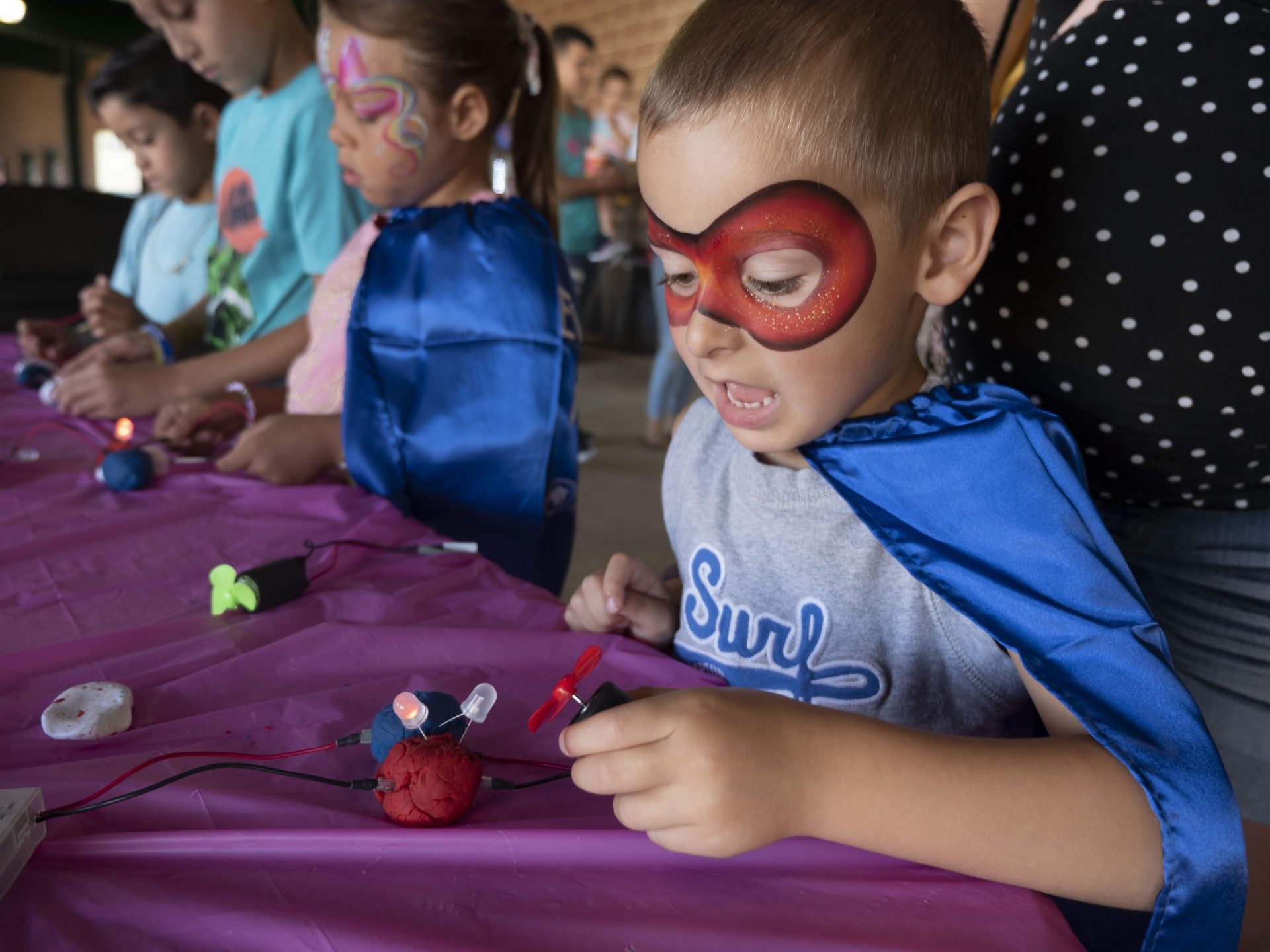 Child dressed as a superhero at the Back to School Bash event