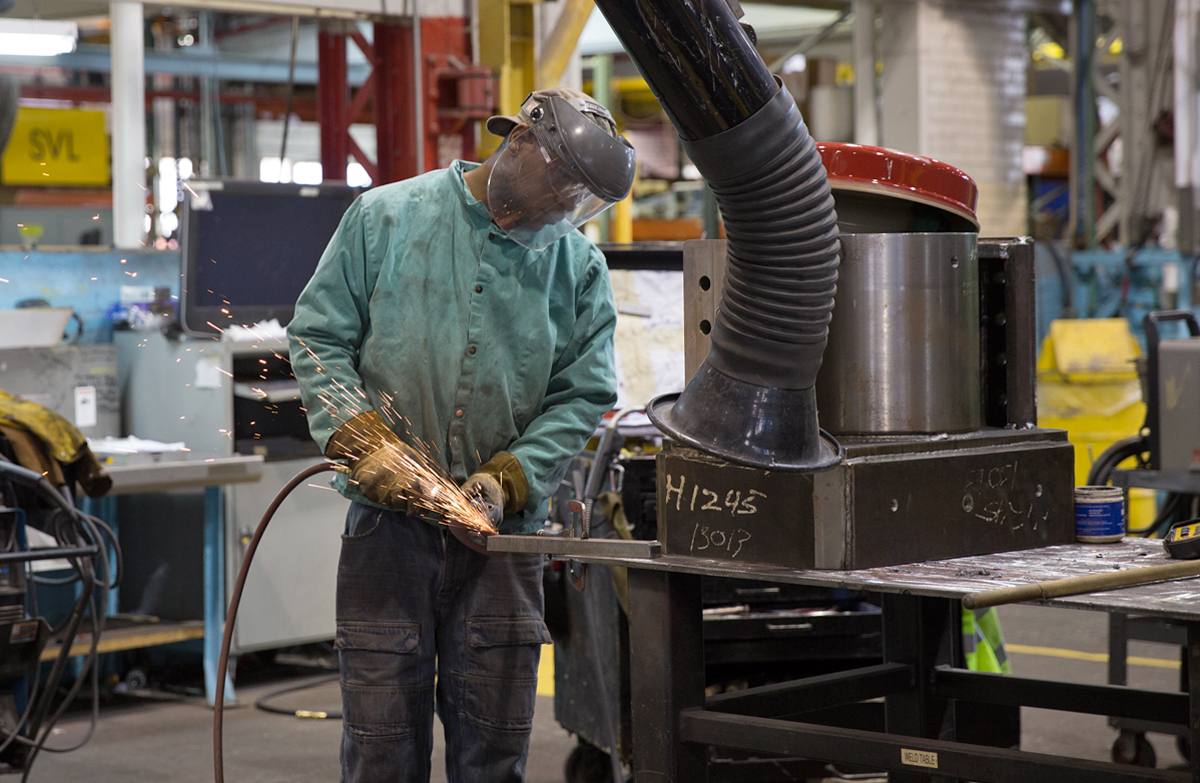 A welder works in the warehouse at Schramm, Inc. headquarters in West Chester, Pa